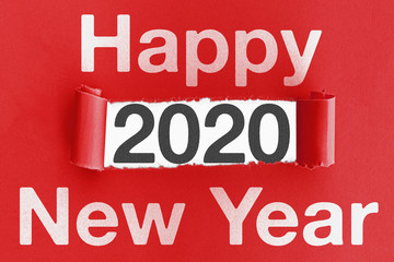 word HAPPY NEW YEAR on torn red paper with numbers 2020 in opening
