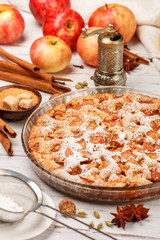 Homemade Apple pie with cinnamon, cardamom, anise and powdered sugar.  Thanksgiving day. Tasty treat in a rustic style. Selective focus