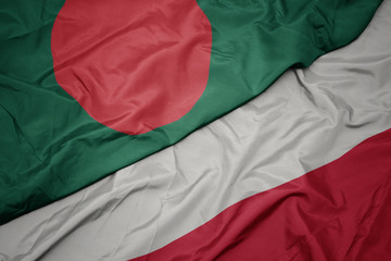 waving colorful flag of poland and national flag of bangladesh.
