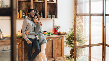 Young loving couple having good time at christmas morning