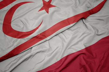 waving colorful flag of poland and national flag of northern cyprus.