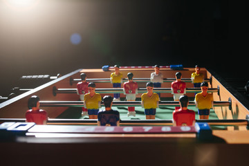 Foosball table soccer. Sport team football players
