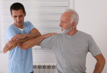 Obraz premium Joint Problems, Arthritis Health and Aging. Chiropractic / Osteopathy treatment, elbow jont pain. Physiotherapy for senior male patient