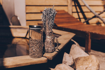 Dried herbs in glass jars on a wooden pool background. Copy space for text. Beauty blogger, salon...