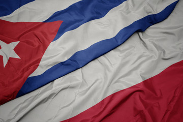 waving colorful flag of poland and national flag of cuba.