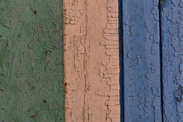 Old wooden planks with cracked multi-colored paint. Design concept