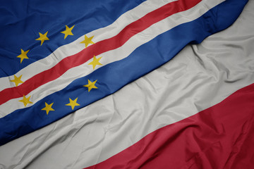 waving colorful flag of poland and national flag of cape verde.
