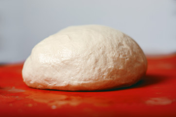 Fototapeta na wymiar close up of flour dough on table, baking concept