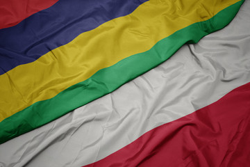 waving colorful flag of poland and national flag of mauritius.