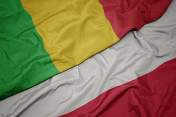 waving colorful flag of poland and national flag of mali.