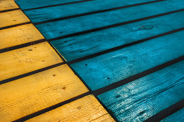 Blue yellow wooden diagonal background with old painted boards