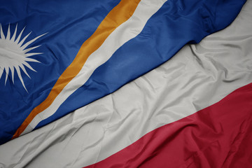 waving colorful flag of poland and national flag of Marshall Islands .