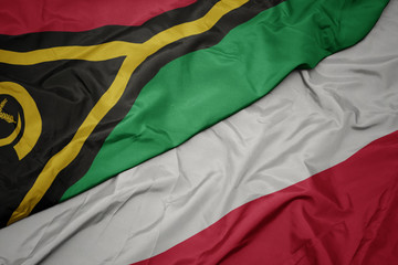 waving colorful flag of poland and national flag of Vanuatu .