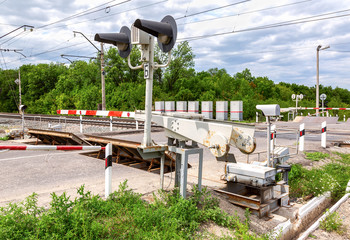 Traffic light and road sign on the railway crossing