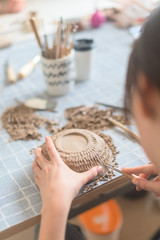 Woman make ceraic plate. Pottery workshop, the process of making ceramic tableware