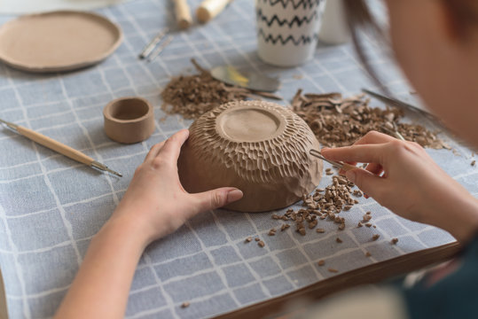 Pottery workshop, the process of making ceramic tableware, women's hands