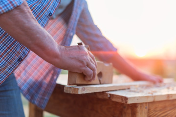 Fototapeta na wymiar Elderly male woodworker hands