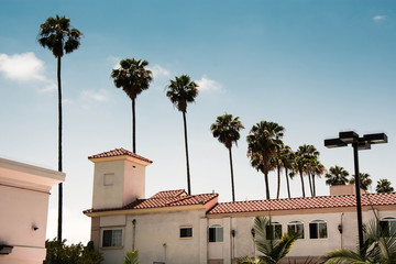 Villa with palm trees in hollywood los angeles california on a sunny day with blue sky.