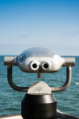 coin operated binoculars pointing to the blue ocean