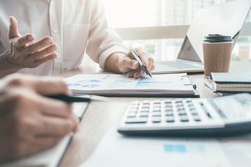 Asian advertising designer creative start-up team discussing ideas in office.