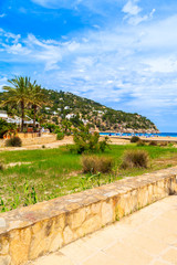 Coastal walkway to beach in beautiful bay of Cala Sant Vicent, Ibiza island, Spain