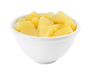 Bowl with pieces of delicious sweet canned pineapple on white background