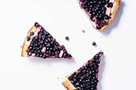 Pieces of summer tart with fresh blueberries