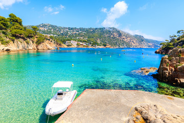 Boat anchoring on beautiful Aiguablava beach, Costa Brava, Catalonia, Spain