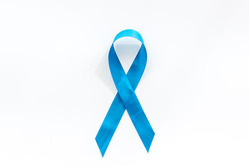 Blue ribbon as symbol disease control on white background top view copy space