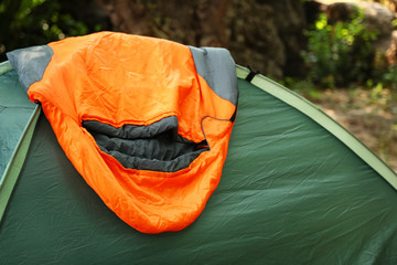Tent with sleeping bag outdoors. Camping gear