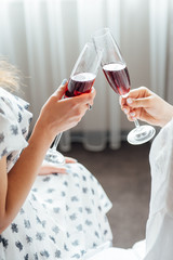 group of people touch champagne glasses and cocktails