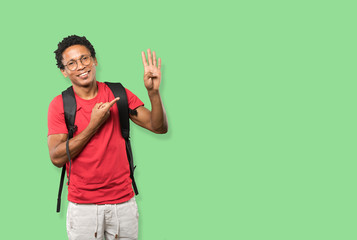 Fototapeta premium Young man making a number four gesture
