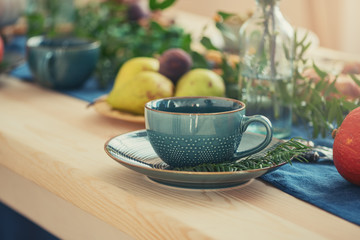 Cup of tea with saucer on table