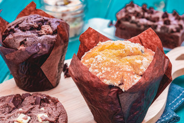 Chocolate Muffin and Vanilla Muffin with Brownie and Chocolate Cookie, Homemade Bakery on Blue Background. Sweets and Desserts on Blue Wood Background
