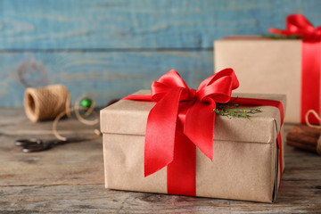 Christmas gifts on table against blue wooden background