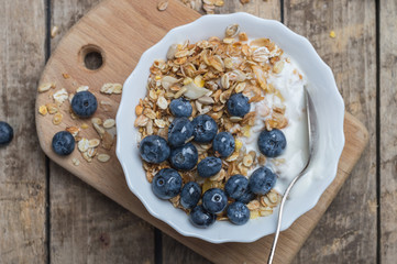 Female hand with a glass of red champagne against the backdrop of a setting lavender field
