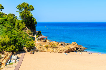 Rocks on stunning beach with azure sea water in beautiful Sa Riera village, Costa Brava, Catalonia, Spain