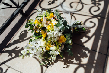 Wedding bouquet from beautiful flowers: pink roses, white and pink ranunculus