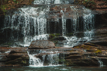 Obraz premium Waterfall in mountain forest