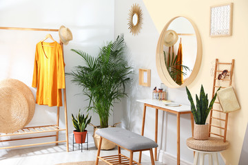 Stylish room interior with little table and comfortable bench