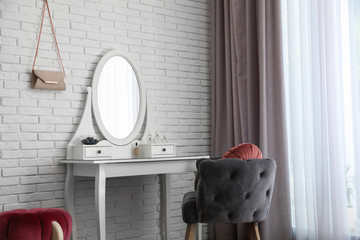 Dressing table with mirror in stylish room interior