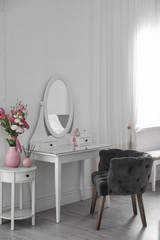 Stylish room interior with white dressing table