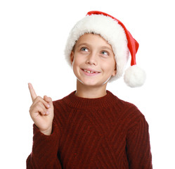 Happy little child in Santa hat on white background. Christmas celebration