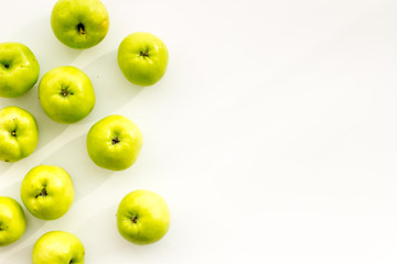 Green apples pattern on white background top view frame copy space