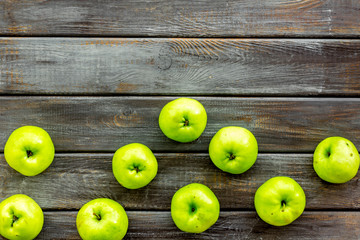 Green apples pattern on dark wooden background top view frame copy space