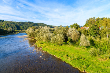 Fototapeta na wymiar View of Dunajec river and green landscape near Nowy Sacz, Poland