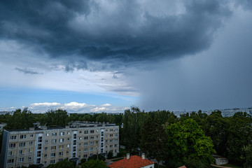 dramatic rain clouds over city rooftops