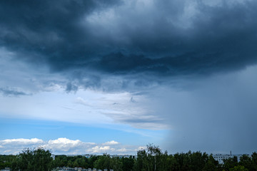 dramatic rain clouds over city rooftops
