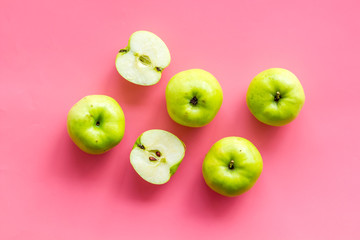Autumn composition with green apple on pink background top view