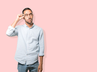 Fototapeta premium Concerned young man doing a gesture of relief